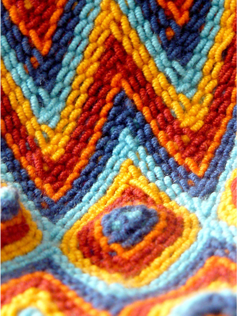 Shoulder strap of the Diamond pattern orange, yellow, red and blue woven shoulder bag with tassels and beads Palmazul Beachwear Wayuu Mochila