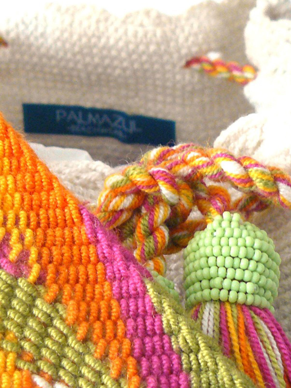 White woven shoulder bag with orange, pink and green strap, with tassels and beads Palmazul Beachwear Wayuu Mochila